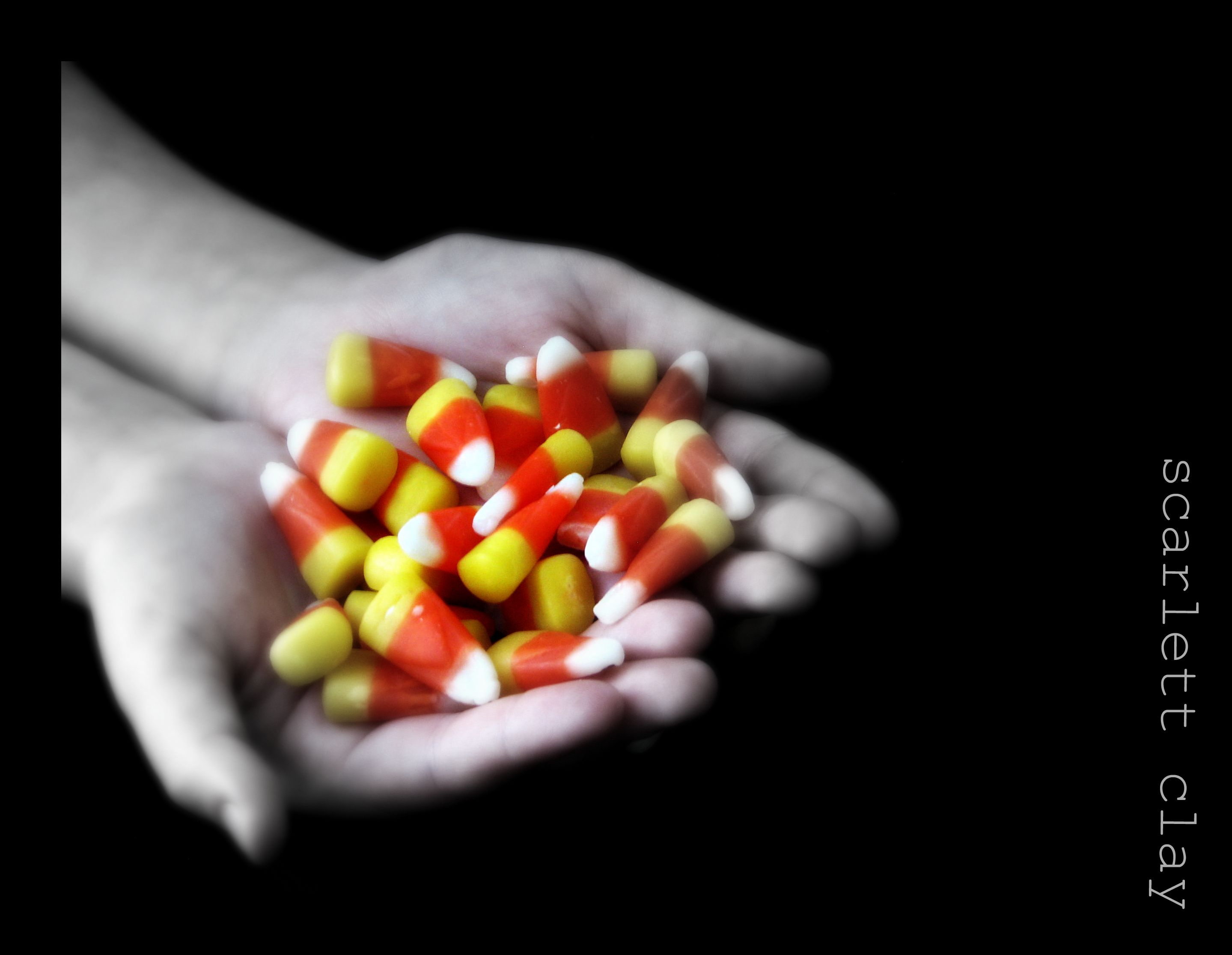 hands holding candy corn